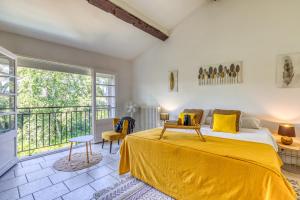 a bedroom with a bed and a balcony at Chambre D'hôtes Le Moulin in Balaruc-le-Vieux +40 photos