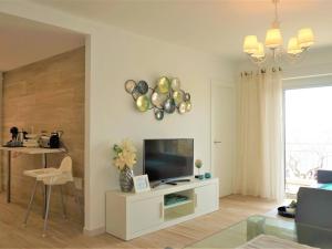 a living room with a flat screen tv on a wall at La perla del mar 2 in Son Servera