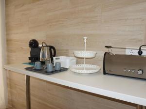a kitchen counter with a coffee maker and a toaster at La perla del mar 2 in Son Servera +18 photos