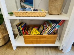 a book shelf filled with books and a basket at Calpe Star in Calpe