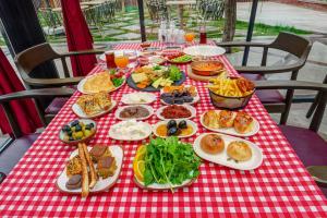 a table with plates of food on a red and white checked table cloth at A La Mode Cappadocia in Göreme