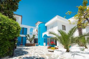 a view of a house with blue and white at Kamari Beach Hotel in Potos +32 photos
