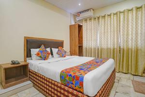 a bedroom with a large bed and a window at Via Maahi Residency in Mumbai