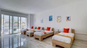 a room with three beds and a balcony at Stunning villa w Private pool TT table Sleeps 14 in St. Julianʼs +57 photos