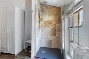 a bathroom with a shower with a glass door at Chambres D'hôtes Chapetit in Saint-Denis-de-Pile +47 photos