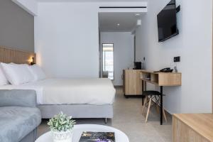 a hotel room with a bed and a couch at Olympus Jankaea in Paralia Katerinis