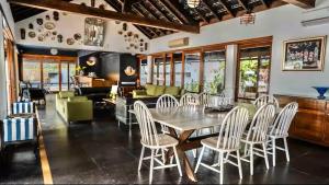 a dining room with a table and chairs at Birdsong,Goa in Tivim