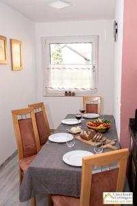 a dining room table with glasses of wine and fruit on it at Unterkunft-Uettingen in Uettingen