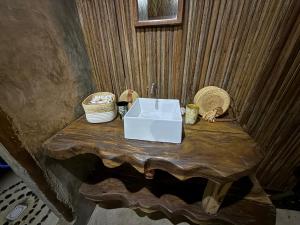 a bathroom with a sink on a wooden table at Madabay's Lodge Nosy Be in Antafondro +95 photos