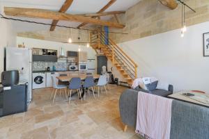 a kitchen and living room with a table and chairs at Chambres D'hôtes Chapetit in Saint-Denis-de-Pile