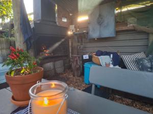a patio with a fireplace and a table with a candle at Reebok Rest in Reebok