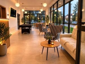a living room with a couch and chairs and a table at Penzión Alma in Poprad