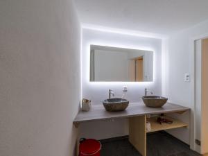 a bathroom with two sinks and a mirror at Private Rooms near Glarus, Shared Bath in Näfels +40 photos