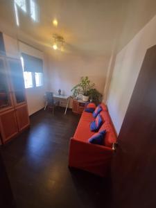 a living room with a red couch and a table at BlueStay in Qiryat Yam