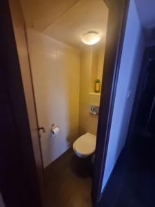 a small bathroom with a toilet and a light at BlueStay in Qiryat Yam