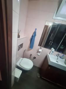 a small bathroom with a toilet and a sink at BlueStay in Qiryat Yam