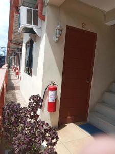 a fire hydrant on the side of a building with a door at Central View Apartelle in Angeles