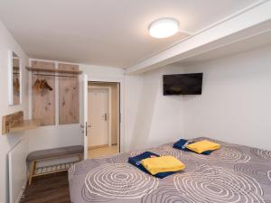 a bedroom with a bed with two yellow pillows on it at Private Rooms near Glarus, Shared Bath in Näfels