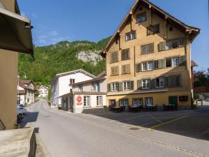 a large building on the side of a street at Private Rooms near Glarus, Shared Bath in Näfels