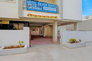 an empty building with a hotel silver suites sign and plants at Via Silver Suites in Hyderabad +30 photos