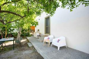 a group of chairs sitting outside of a house at Topos Patela in Kalithies