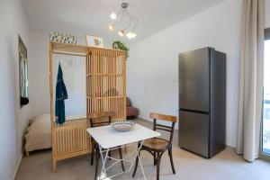 a kitchen with a table and a refrigerator at Topos Patela in Kalithies