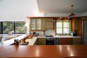 a kitchen with wooden cabinets and a counter top at Petra Kazarma in Kymi +22 photos