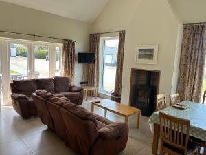 a living room with a couch and a table at Strule Cottage in Strabane