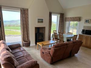a living room with a couch and a table at Strule Cottage in Strabane