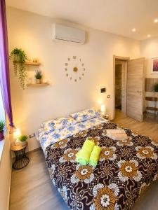 a bedroom with a large bed with yellow pillows at Stella Marys Sud in Olbia