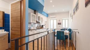 a kitchen with a staircase with a table and chairs at Rifugio Del Generale - comfort & relax in Pizzo