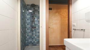 a bathroom with a shower with a glass door at Rifugio Del Generale - comfort & relax in Pizzo +8 photos
