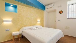 a bedroom with a white bed and a blue ceiling at Rifugio Del Generale - comfort & relax in Pizzo