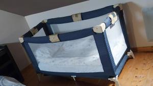 an open suitcase with a bed in a room at WELCOME Bayeux in Bayeux