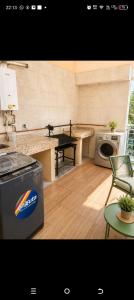 a kitchen with a counter top and a dishwasher at Amplio y elegante monoambiente , de lujo in La Paz +3 photos