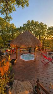 a deck with a hut and a swimming pool at La lyalis in Aiguines
