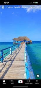 a boardwalk with a pier in the water at La luna di zanzibar in Kiwengwa