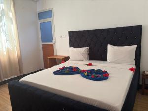 a bedroom with a large bed with two baskets on it at La luna di zanzibar in Kiwengwa