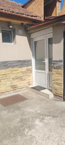 a white door of a house with a driveway at DIAstan in Zrenjanin