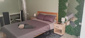 a rendering of a bedroom with a bed with purple pillows at DIAstan in Zrenjanin