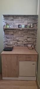 a kitchen with a counter and a brick wall at DIAstan in Zrenjanin