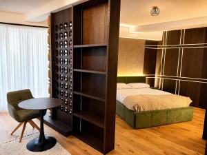 a bedroom with a bed and a chair and a table at Design-Apartment Siegen Oberstadt in Siegen