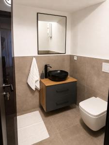 a bathroom with a sink and a toilet at Design-Apartment Siegen Oberstadt in Siegen