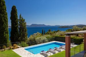 a villa with a swimming pool and a view at EOS Luxury Villa in Nydri