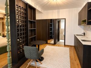 a small kitchen with a chair and a bedroom at Design-Apartment Siegen Oberstadt in Siegen