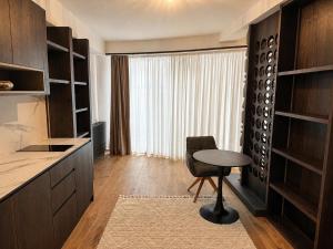 a kitchen with a table and a chair and a window at Design-Apartment Siegen Oberstadt in Siegen