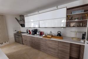 a kitchen with stainless steel cabinets and a large window at Palazzo Di Acqua in Le Mans