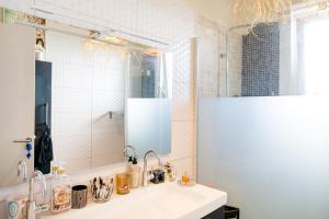 a bathroom with a sink and a mirror at Maison Cosy Bohème Chic Biarritz in Biarritz +13 photos