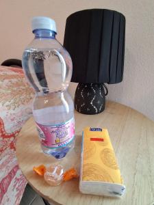 a bottle of water and a book on a table at Stella Marys Sud in Olbia