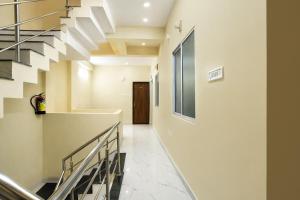 a hallway with stairs leading to a door at Via Mannat in Indore